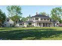 Stately two-story home with a large front lawn and covered front porch at 10101 Tarpon Springs Rd, Odessa, FL 33556