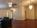 Inviting living room with neutral tones, hardwood floors, ceiling fan, and lots of natural light at 11716 Cr 672 Hwy, Riverview, FL 33579