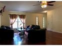 Spacious living room features gleaming hardwood floors, ample natural light, and a comfortable seating area at 11716 Cr 672 Hwy, Riverview, FL 33579