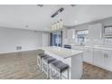 Bright, open floor plan featuring an island with seating and modern pendant lighting at 11973 80Th Ave, Seminole, FL 33772