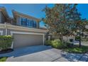 Attractive townhome with a two-car garage and beautifully maintained landscaping in front yard at 13207 San Blas Loop, Largo, FL 33774
