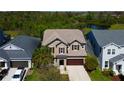 Aerial view of home showing landscaping, location, water, and other surrounding properties at 13812 Fairway Bunker Dr, Tampa, FL 33626