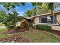 Charming single-story home with an enclosed front porch and well-maintained landscaping at 1426 Ingram Dr # 1426, Sun City Center, FL 33573