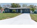 Charming home featuring a well-manicured lawn, freshly painted exterior, and lovely landscaping at 1605 Crown St, Clearwater, FL 33755
