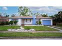 Charming single-story home with a well-manicured lawn, featuring blue painted trim and a chimney at 2448 14Th S Ave, St Petersburg, FL 33712