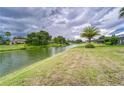 Serene backyard view overlooking lush greenery and a tranquil pond at 2926 Spring Hammock Dr, Plant City, FL 33566