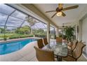 Outdoor patio seating area with a screen and view of the pool and backyard at 2926 Spring Hammock Dr, Plant City, FL 33566
