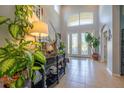 The bright foyer features a high ceiling, tile floors, decor and a glass front door at 309 Royal Bonnet Dr, Apollo Beach, FL 33572