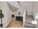 Inviting entryway featuring wood-look tile flooring, a staircase, and stylish décor, creating a warm and welcoming atmosphere at 3139 Marine Grass Dr, Wimauma, FL 33598