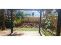 Backyard pergola overlooking a lush, green lawn ready for entertaining or relaxing at 409 S Arrawana Ave, Tampa, FL 33609