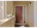 Inviting condo front door featuring a side window, unit number 201, and a plant at 4160 Pinelake Ln # 201, Tampa, FL 33618
