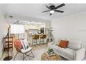 Living room boasts an open floor plan with a ceiling fan, updated decor and flows into the stylish kitchen at 4207 W San Rafael St # E, Tampa, FL 33629