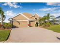 Beautiful single-story home with a three-car garage, paver driveway, and well-maintained lawn at 4315 70Th E Ave, Ellenton, FL 34222
