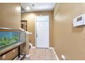 Inviting foyer features tiled flooring, a white front door, and space for decor and storage at 5831 Leopardstown Dr, Tampa, FL 33610