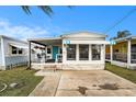 Charming single-story home featuring a cozy covered porch and neat landscaping on a sunny day at 647 Yawl Ln, Palm Harbor, FL 34683