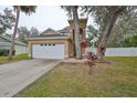 Charming home featuring an attached two-car garage, mature trees and well maintained landscaping at 6930 Summer Harbor Ln, Riverview, FL 33578