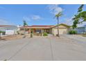 Charming single-story home with double front doors, a two car garage, and circular driveway with well-maintained landscaping at 727 Flamingo Dr, Apollo Beach, FL 33572