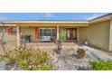 Charming home featuring a welcoming front porch, a double door entry and colorful landscaping for instant curb appeal at 727 Flamingo Dr, Apollo Beach, FL 33572