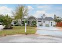 Inviting single-story home featuring lush greenery and a well-manicured front yard at 1016 Greenleaf Way, Tarpon Springs, FL 34689