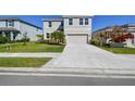 Well-maintained two-story home featuring a two-car garage and landscaping at 10741 Charlotte Dr, Parrish, FL 34219