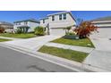Exterior view of a two-story home with well-maintained landscaping and lawn at 10741 Charlotte Dr, Parrish, FL 34219