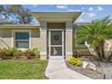 Welcoming front entrance with a screened door, and decorative landscaping at 1221 Dustin Rd, North Port, FL 34288