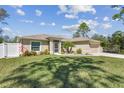 Charming one-story home with a well-maintained lawn and a two-car garage at 1221 Dustin Rd, North Port, FL 34288