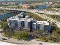Aerial view showcases a multi-story condo with balconies, water views, and highway access at 201 W Laurel St # 811, Tampa, FL 33602