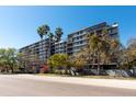 Exterior shot of a multi-story condo building surrounded by palm trees and lush landscaping at 201 W Laurel St # 811, Tampa, FL 33602