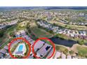 Aerial view showcases the home's location within a community with a pool, golf course, and water features at 23717 Coral Ridge Ln, Land O Lakes, FL 34639