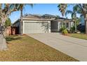 Well-kept single-story home with a spacious driveway and attached two-car garage at 30119 Rattana Ct, Wesley Chapel, FL 33545