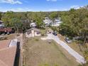 Aerial view of the property featuring a house, a shed, and two cars parked in the driveway at 4020 Amber Rd, Valrico, FL 33594