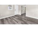 Neutral colored room with modern grey vinyl flooring and white door at 9315 N 19Th St, Tampa, FL 33612