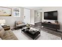 Cozy living room with a modern sofa, rug, and a large smart television at 9315 N 19Th St, Tampa, FL 33612