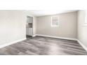 Bright room with modern grey vinyl flooring and neutral walls at 9315 N 19Th St, Tampa, FL 33612