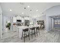 Bright, modern kitchen with white cabinetry, stainless appliances, and an island with barstool seating at 104 1St Ne Ave, Lutz, FL 33549