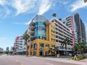 Contemporary condo building featuring a unique cylindrical glass facade, balconies, and convenient parking garage at 1208 E Kennedy Blvd # 1122, Tampa, FL 33602