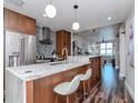 Modern kitchen featuring stainless appliances, stone countertops, and bar seating with pendant lighting at 1208 E Kennedy Blvd # 1122, Tampa, FL 33602