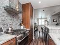 Modern kitchen featuring stainless steel appliances, stone countertops, and a tiled backsplash at 1208 E Kennedy Blvd # 1122, Tampa, FL 33602