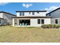 A spacious backyard offers outdoor entertaining and recreational opportunities, with a patio, a lawn, and beautiful landscaping at 14733 Gallop Run Dr, Lithia, FL 33547