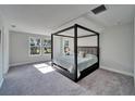 Spacious bedroom with carpeted floors, natural light, and a four-poster bed at 14733 Gallop Run Dr, Lithia, FL 33547