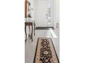 Inviting foyer with tiled floor, elegant console table and decor, leading to the rest of the home at 16946 Oval Rum Dr., Wimauma, FL 33598