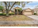 Inviting single-Gathering home featuring manicured landscaping, a two-car garage, and an inviting front entrance at 19223 Wind Dancer St, Lutz, FL 33558