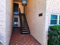 Stairwell leading to the units with tiled floor and building address at 205 Dogwood Cir # 205, Seminole, FL 33777