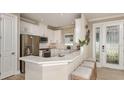 Bright, modern kitchen with stainless steel appliances, white cabinetry, and a breakfast bar at 29513 Velletri Ln, Wesley Chapel, FL 33543
