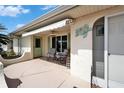 Inviting outdoor patio with comfortable seating under a retractable awning, perfect for relaxation and enjoying the surroundings at 312 Fairside Ct # 12, Sun City Center, FL 33573