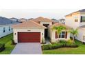 Charming single-story home with a well-manicured lawn and a brick paved driveway at 32768 Tree Of Life Ave, Wesley Chapel, FL 33543
