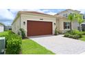 Well-maintained single-story home with a brick paved driveway and a two-car garage at 32768 Tree Of Life Ave, Wesley Chapel, FL 33543