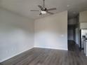Bright, open living room featuring hardwood floors and a contemporary ceiling fan, ideal for relaxation at 3312 Lila St, Tampa, FL 33610