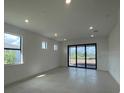 Spacious living room featuring tile floors, recessed lighting, and sliding glass doors at 5014 Coastal Oak Ct, Lakewood Ranch, FL 34211